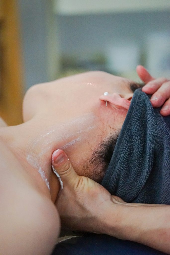 a man laying down with a towel on his head